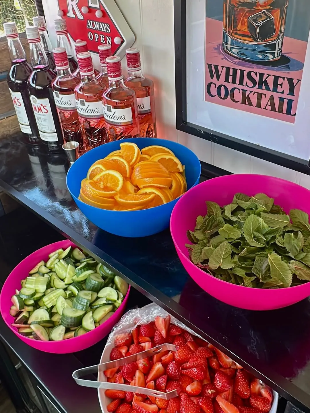 Fresh orange, mint, cucumber and strawberry garnishes ready at the bar